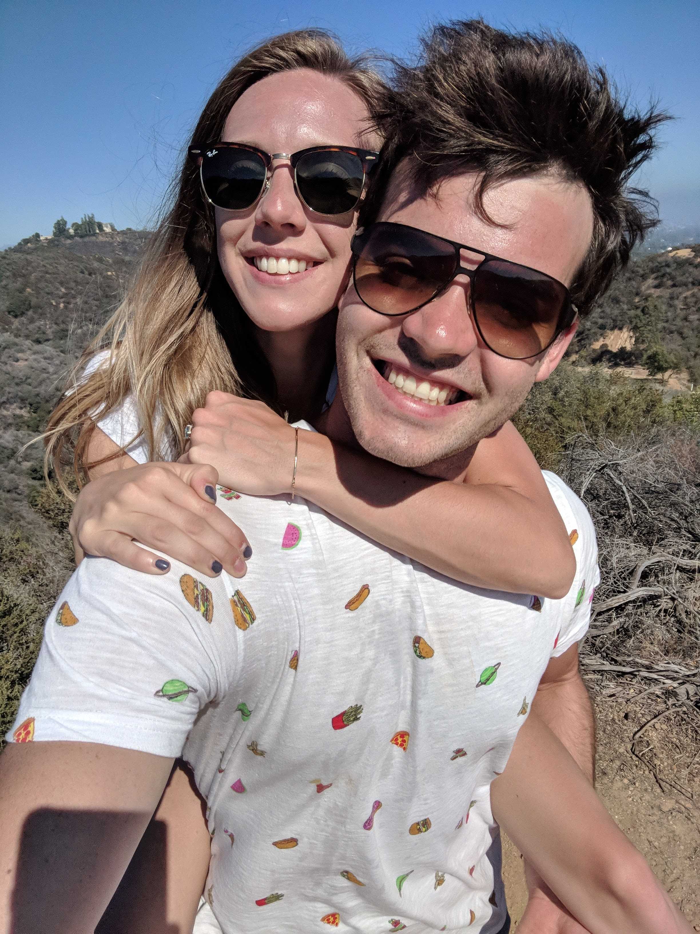 Danny and Bailey smiling together on a sunny hike