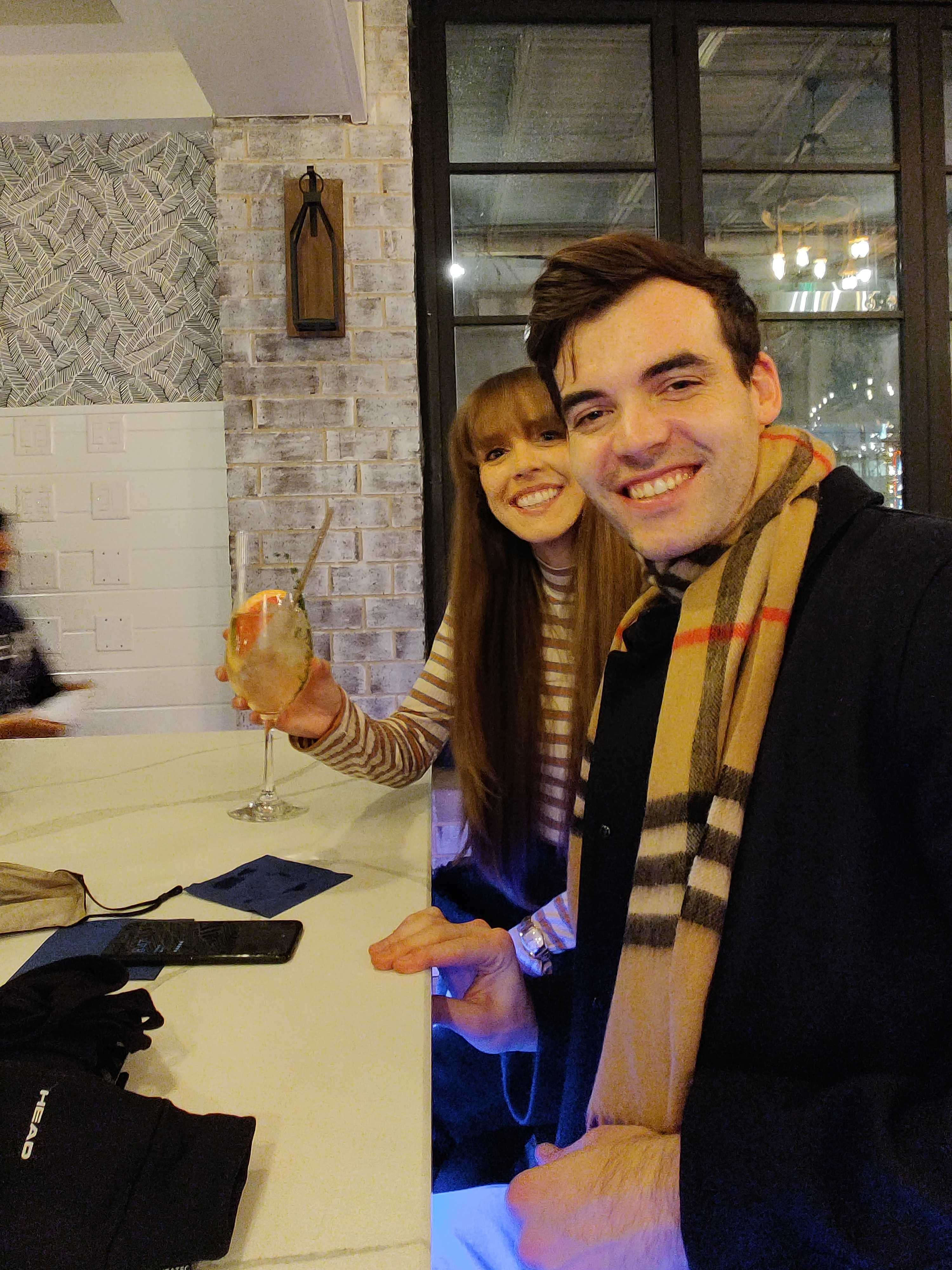 Danny and Bailey sharing drinks on a cozy night out