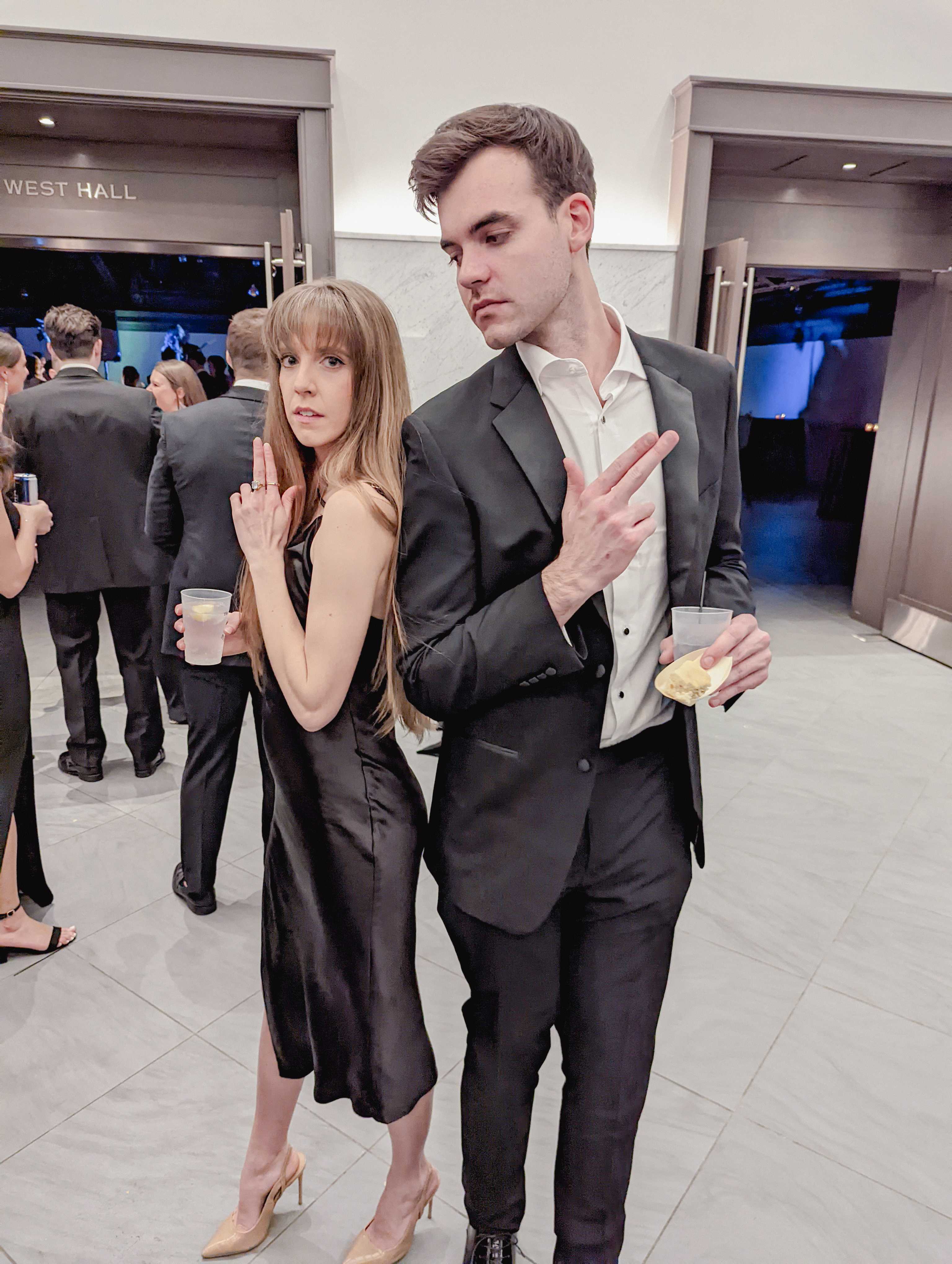Danny and Bailey posing playfully at a formal event